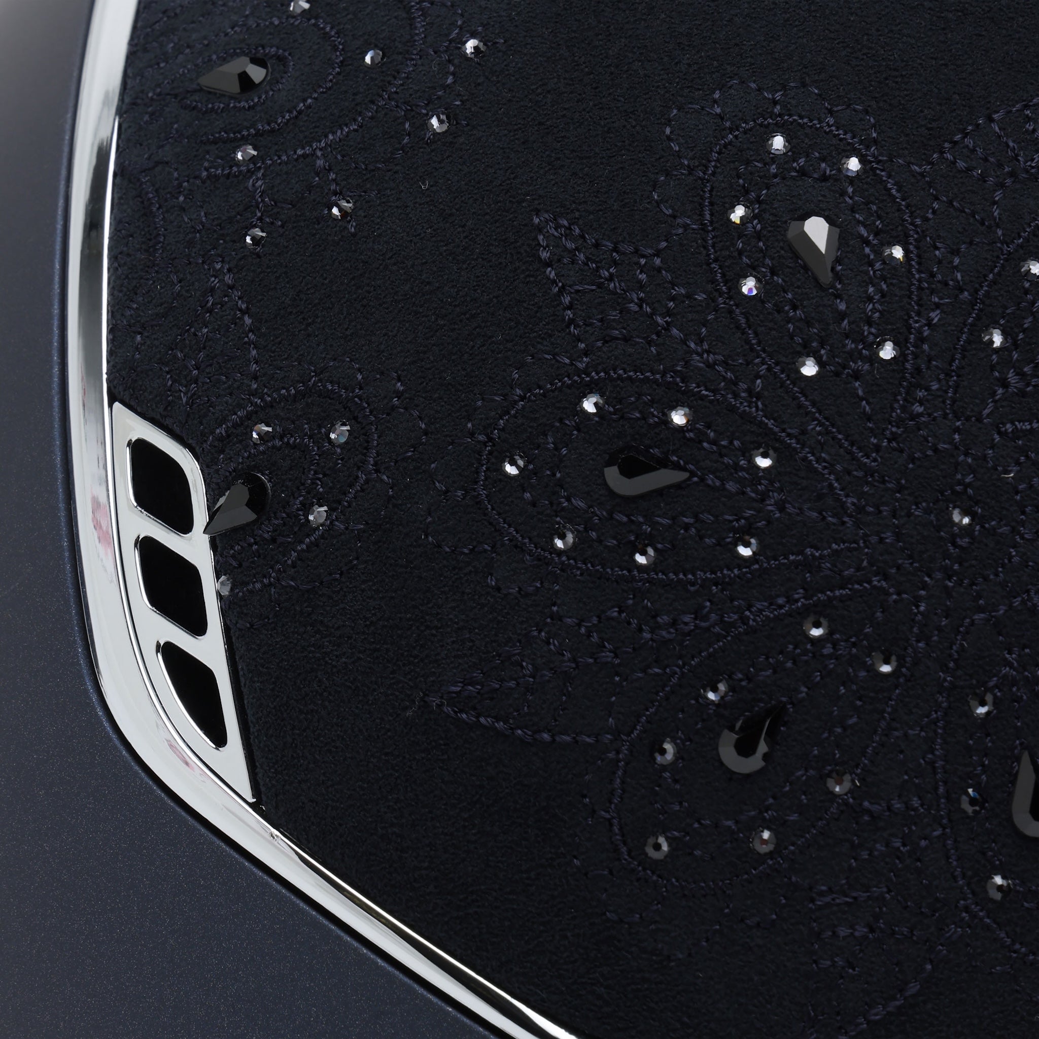 Samshield Miss Shield Shadowmatt 2.0 riding helmet with Crystal Bloom top, navy band, black chrome trim, and decorative blazon detail.