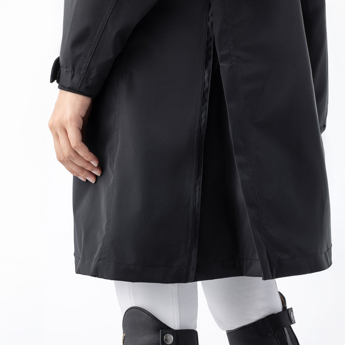 Equiline Ladies Eqextre black waterproof jacket detail, showing the rear vent slit and longline hem for freedom of movement.