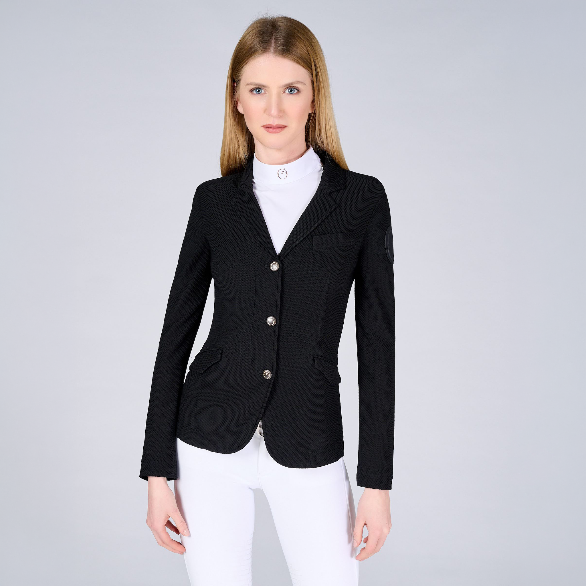 Black Vestrum Ladies Valencia Show Jacket displayed on a hanger, highlighting its tailored fit and elegant design for equestrian events.