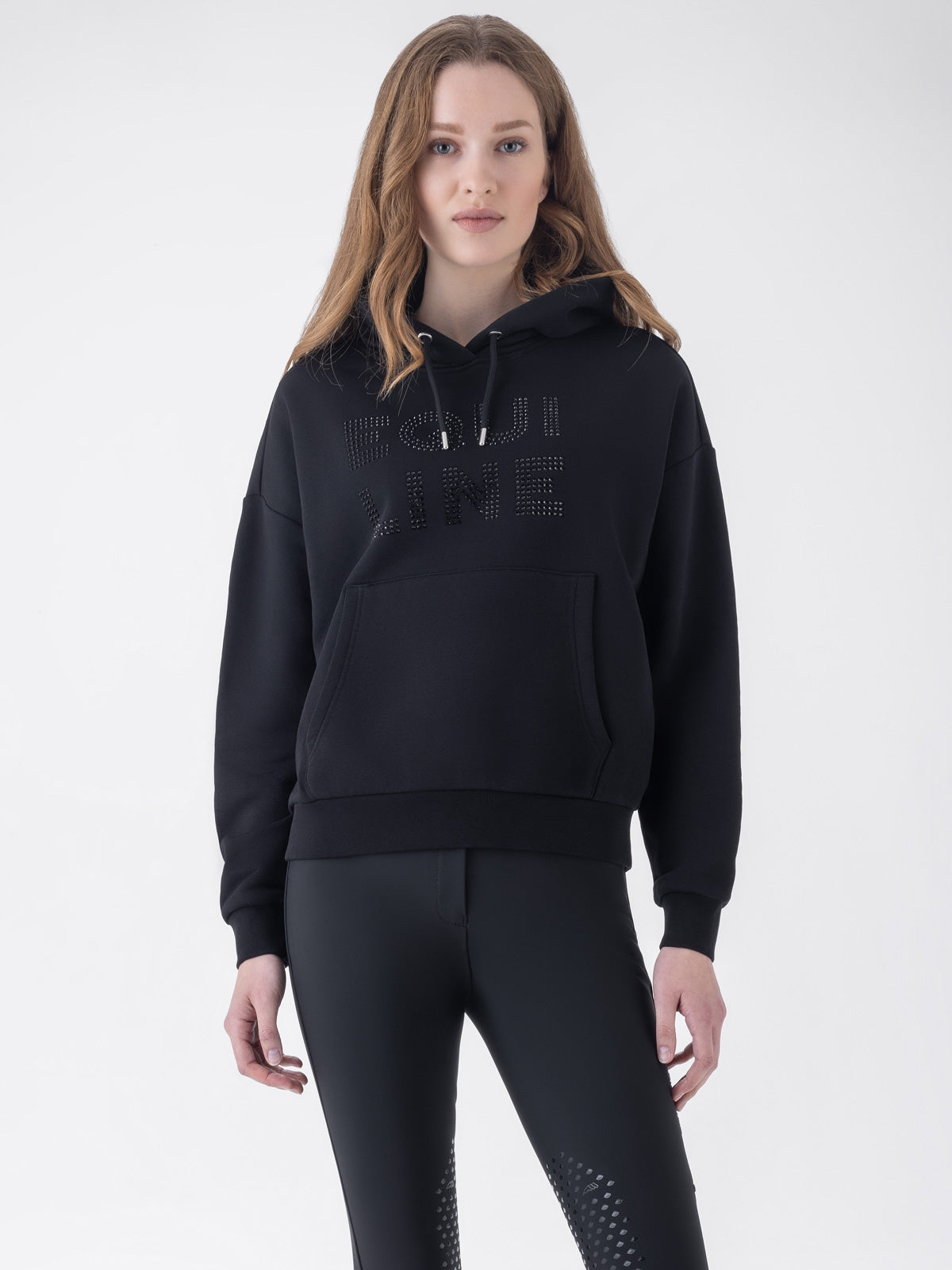 Equiline Ladies Eqglam Oversized Hoodie in Black, front view of the oversized hoodie with kangaroo pocket and rhinestone Equiline logo.