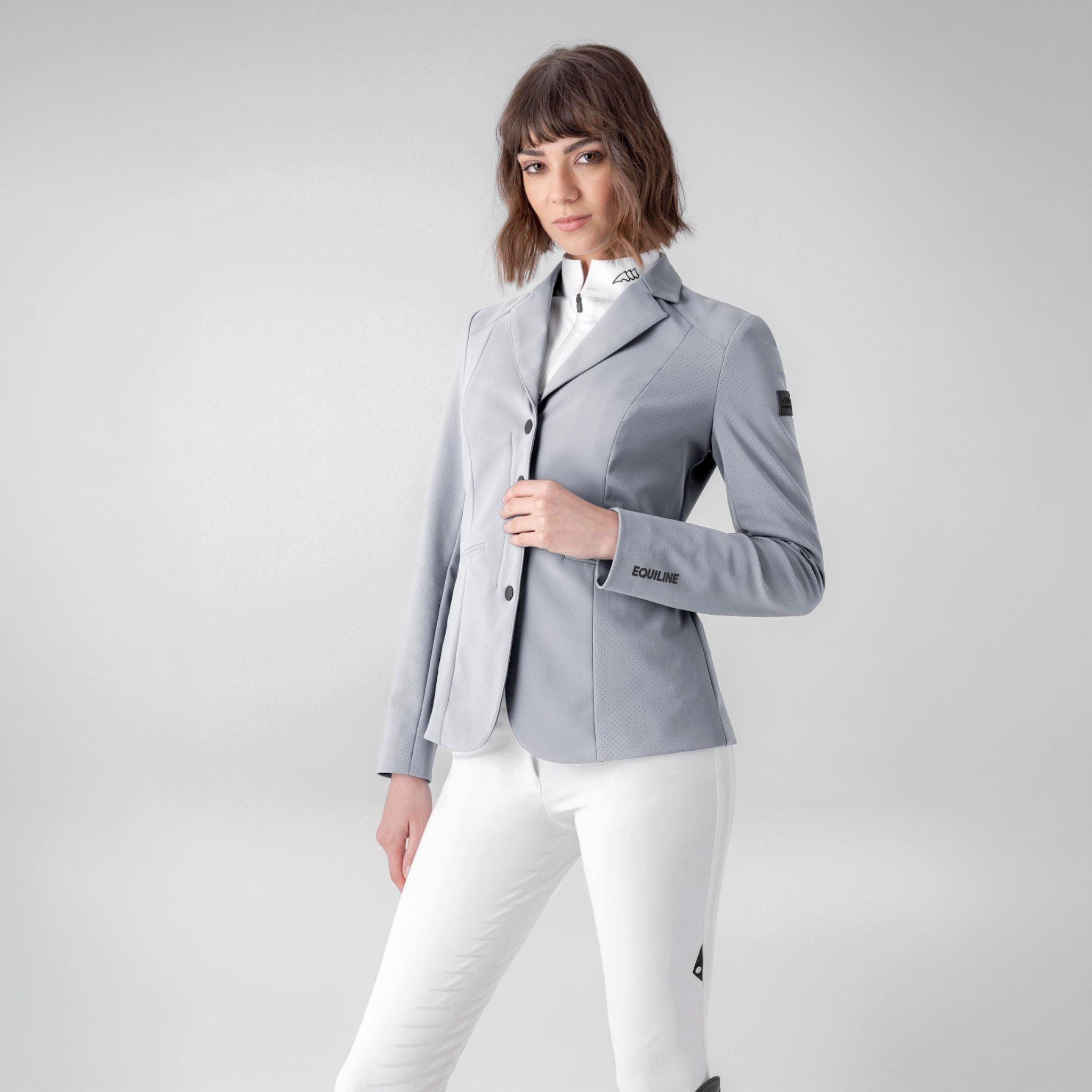 Grey Equiline Ladies Casur Show Jacket displayed on a hanger, showcasing tailored fit and elegant design for equestrian competitions.