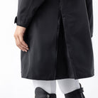Equiline Ladies Eqextre black waterproof jacket detail, showing the rear vent slit and longline hem for freedom of movement.