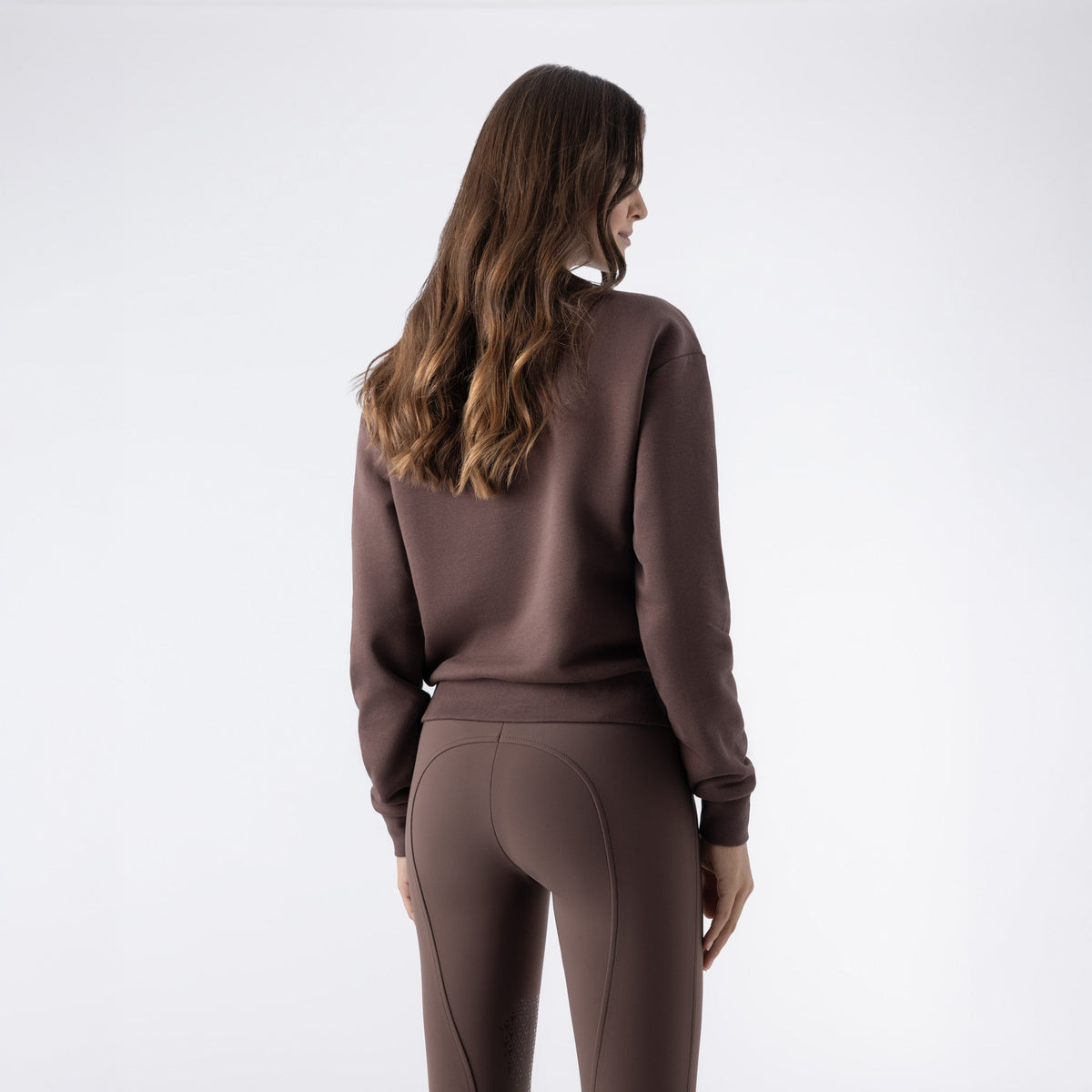 Equiline Ladies Eqzzie cocoa powder crewneck sweatshirt, rear view showing the ribbed hem and embroidered sleeve logo.