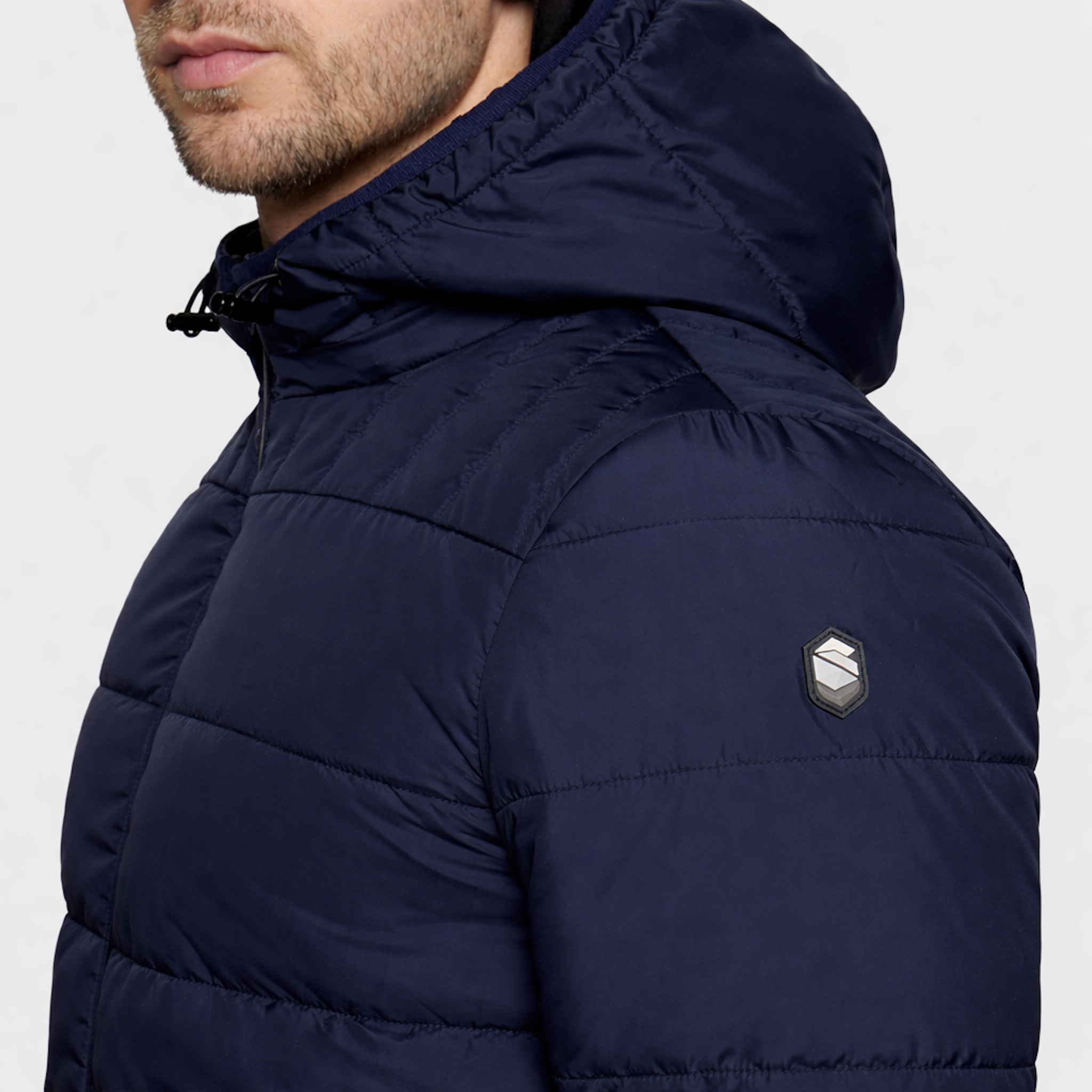 Samshield men's Aspen puffer jacket in navy, showcasing a close-up of the quilted design and front zipper detail.
