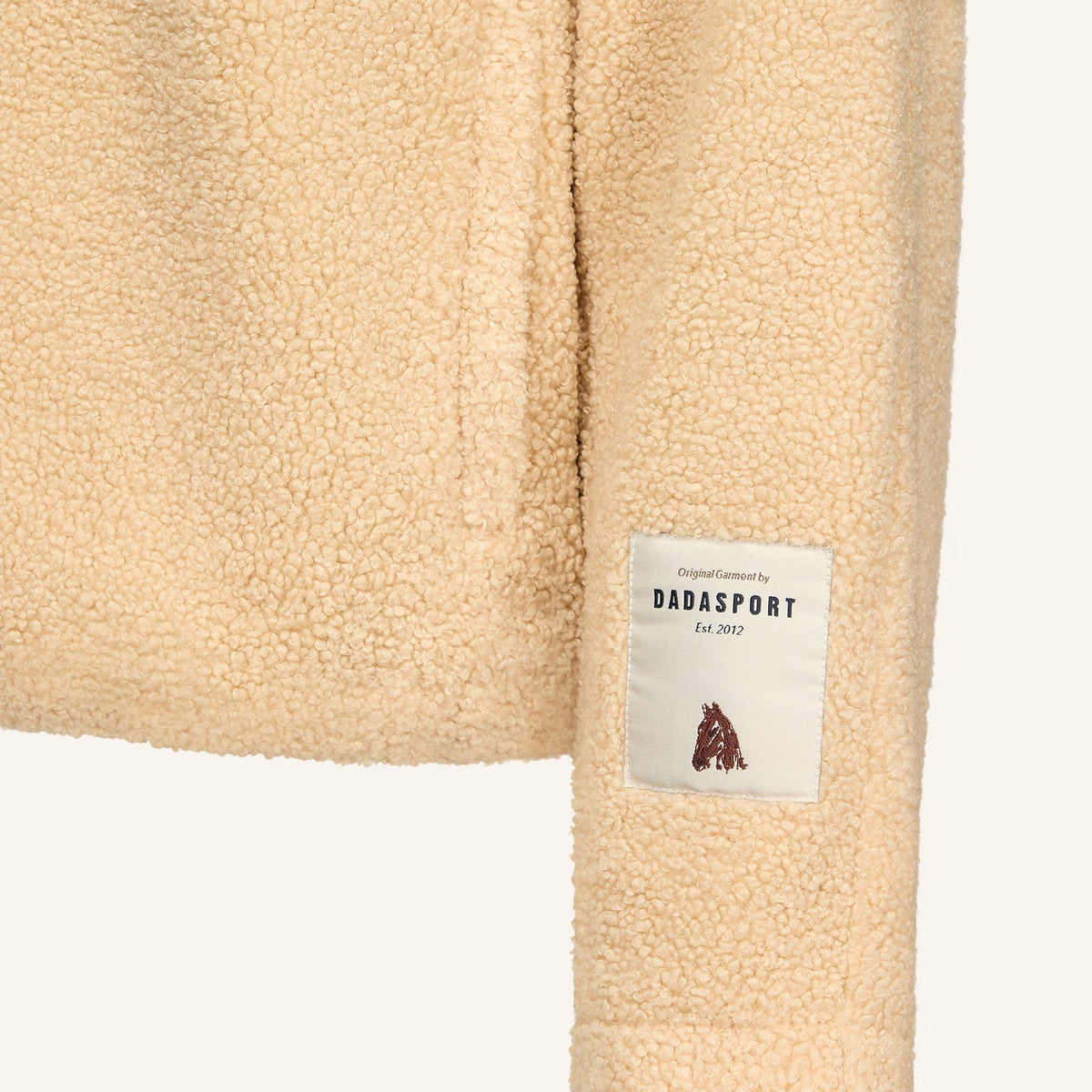 Dada Sport Ladies Tabalou Fleece in Off White, close-up of the hem and Dada Sport label