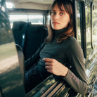 Dada Sport Ladies Consul Technical Riding Turtle-Neck in Oxyde Green worn by a rider sitting in a car