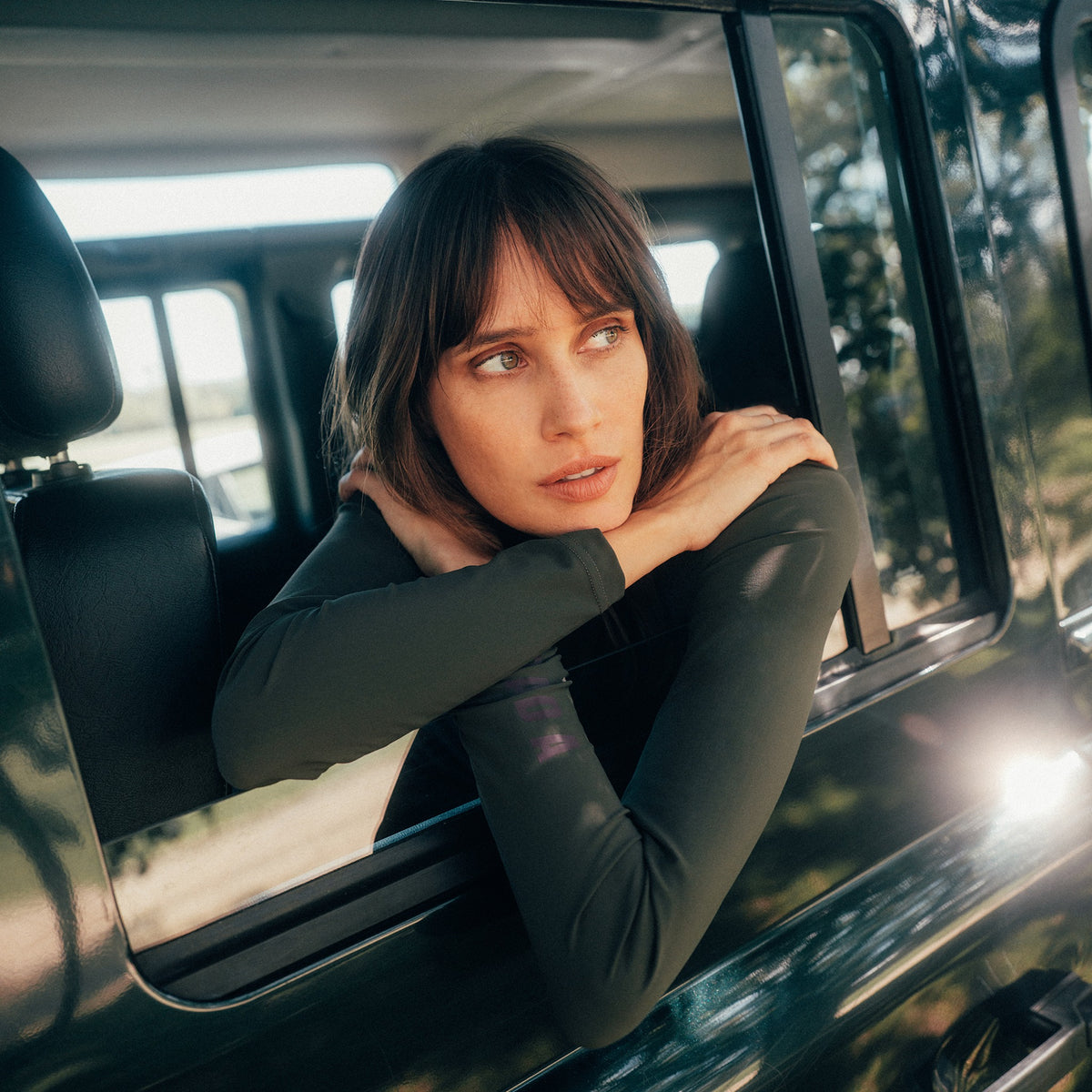 Dada Sport Ladies Consul Technical Riding Turtle-Neck in Oxyde Green worn by a rider leaning from a car window
