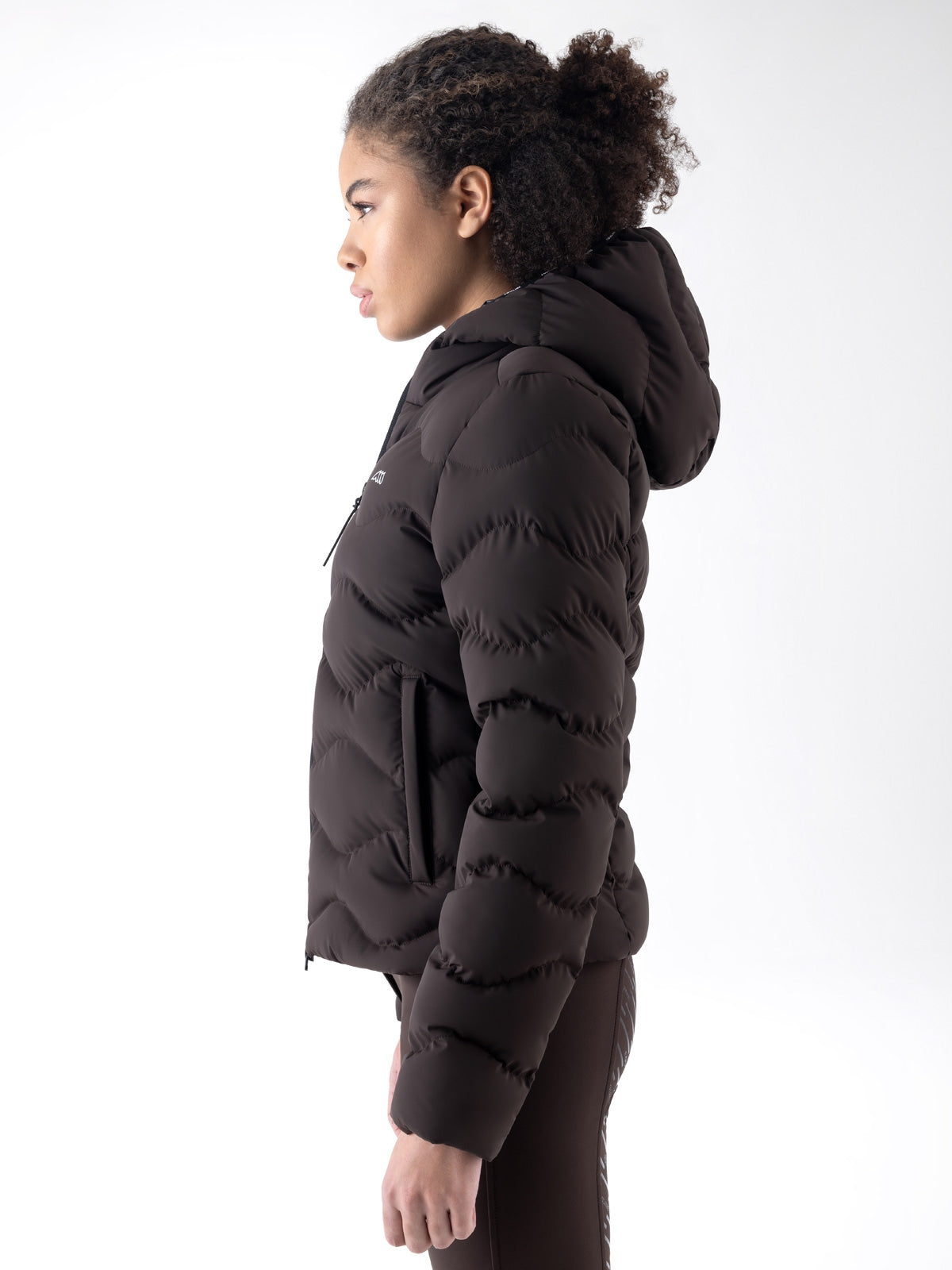 Equiline Ladies Eqcentry Padded Jacket in Coffee Bean, detail view of the hooded Eco-Duvet padded jacket with printed Equiline logo on the chest.
