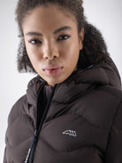 Equiline Ladies Eqcentry Padded Jacket in Coffee Bean, detail view of the hooded Eco-Duvet padded jacket with printed Equiline logo on the chest.