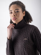 Equiline Ladies Eqlover High Neck Jumper in Coffee Bean, detail view of the soft-touch high neck jumper with beige embroidered Equiline logo.