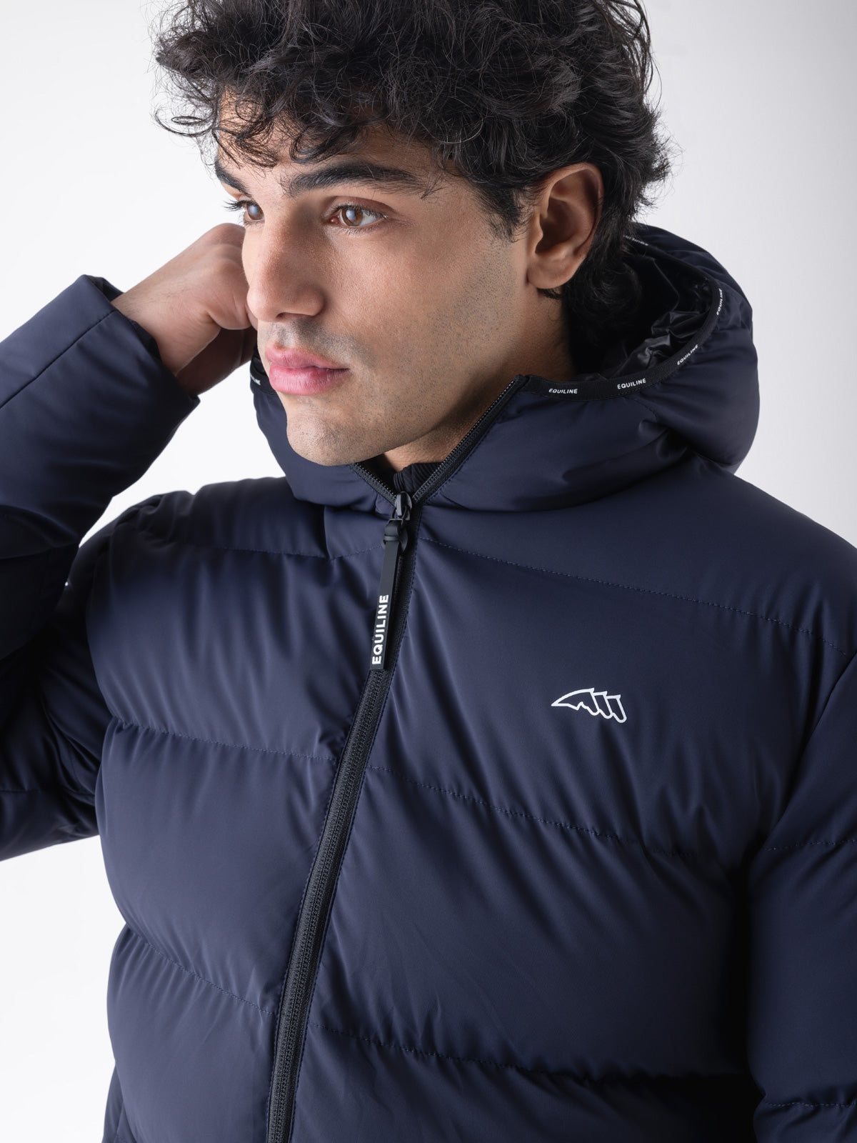 Equiline Mens Eqcan Padded Jacket in Blue, detail view of the hooded Eco-Duvet padded jacket with two-way zip and Equiline logo tape.
