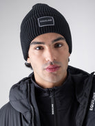 Equiline Unisex Eqcap Knitted Hat in Black, detail view of the microfleece-lined knitted beanie with jacquard Equiline logo patch.