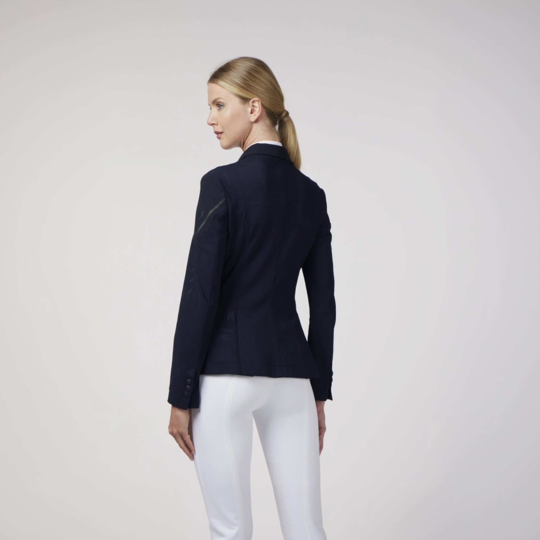 Navy Vestrum Ladies Capri Show Jacket displayed on a hanger, showcasing tailored fit and elegant design for equestrian events.